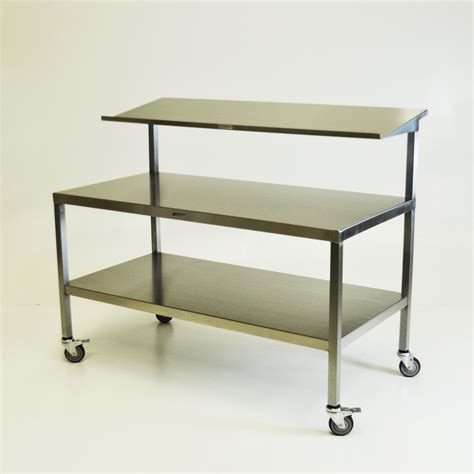 Back table - OR Back Table Model 429 Adjustable. 429 Adjustable Big Case Back Table. Has a variable main surface height of 29″ – 38″ / 73.7 – 96.5 cm (floor to main surface). When upper tier is in the storage position, the table can be used as a single tier back table. Product Literature. 